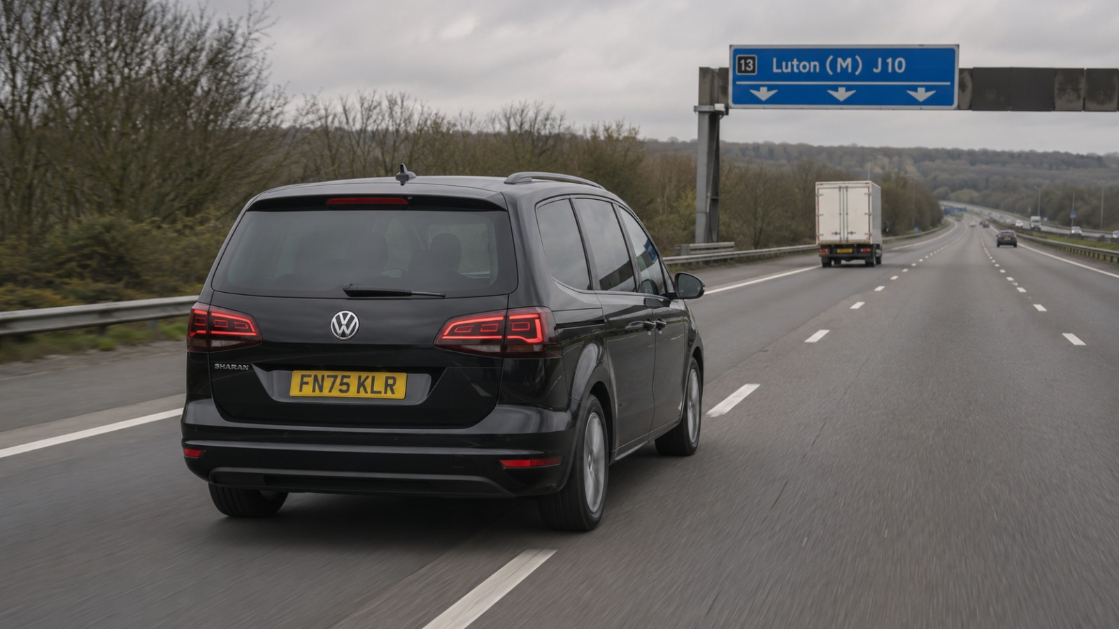 Black VW Sharan 2025 MPV6 taxi travelling southbound on the M1 motorway from Milton Keynes to Luton Airport