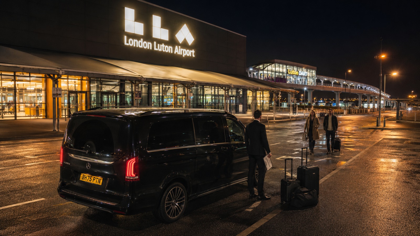 Black Mercedes V-Class 2025 MPV8 taxi at Luton Airport short-stay pickup at night for the Milton Keynes route