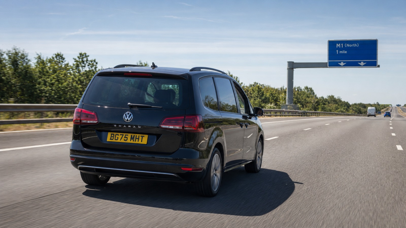 Black VW Sharan 2025 MPV6 taxi travelling on the M25 motorway towards Luton Airport