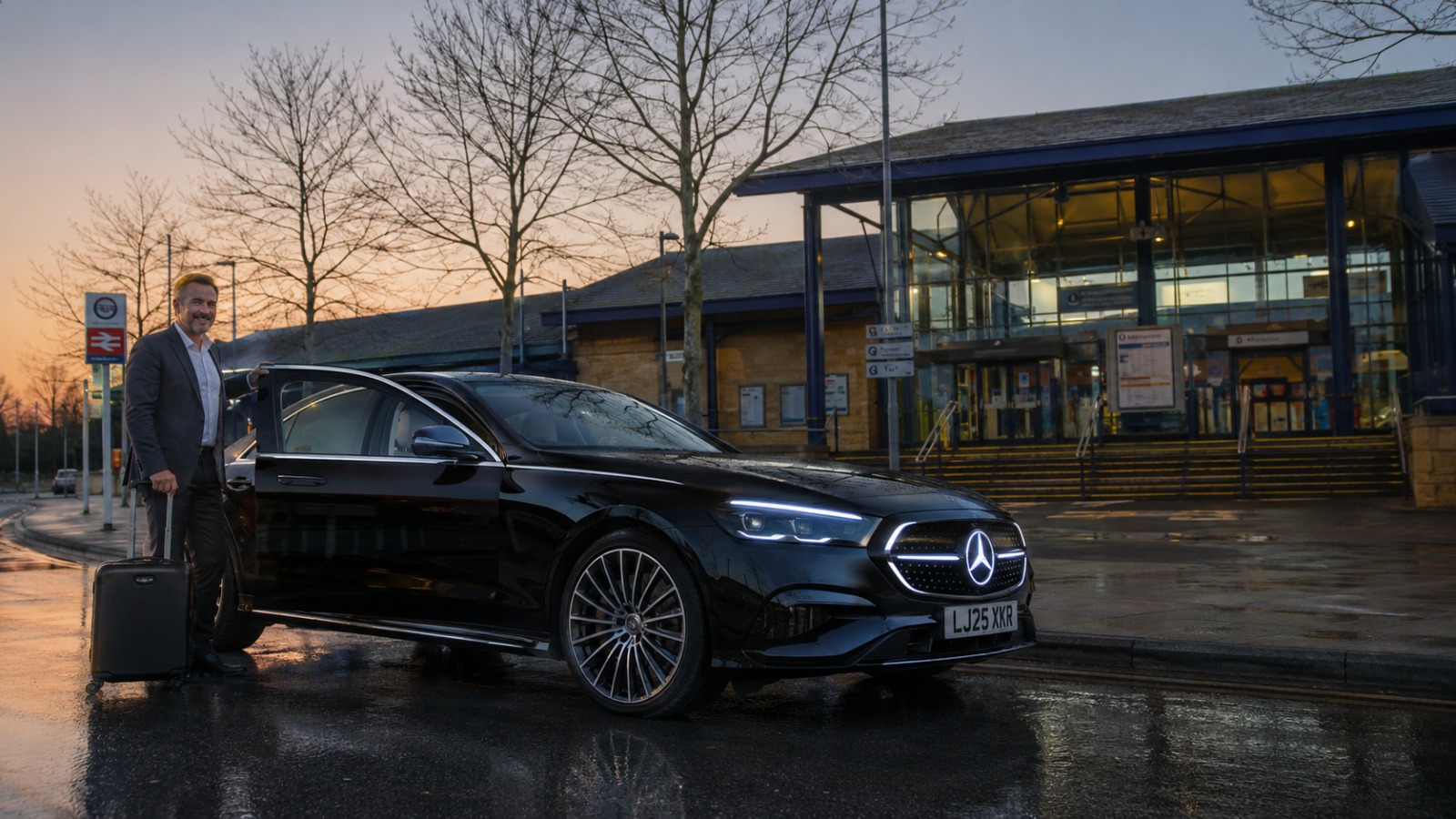 Black Mercedes E-Class 2025 saloon taxi outside Oxford Rail Station ready for a Luton Airport transfer