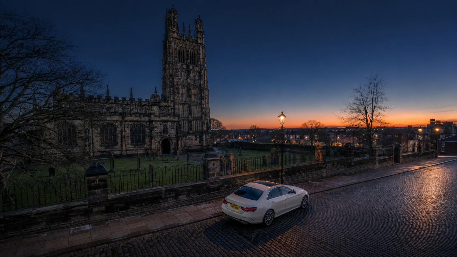 Executive saloon at St Giles Church Wrexham at blue hour, overhead view of pre-dawn Manchester Airport departure